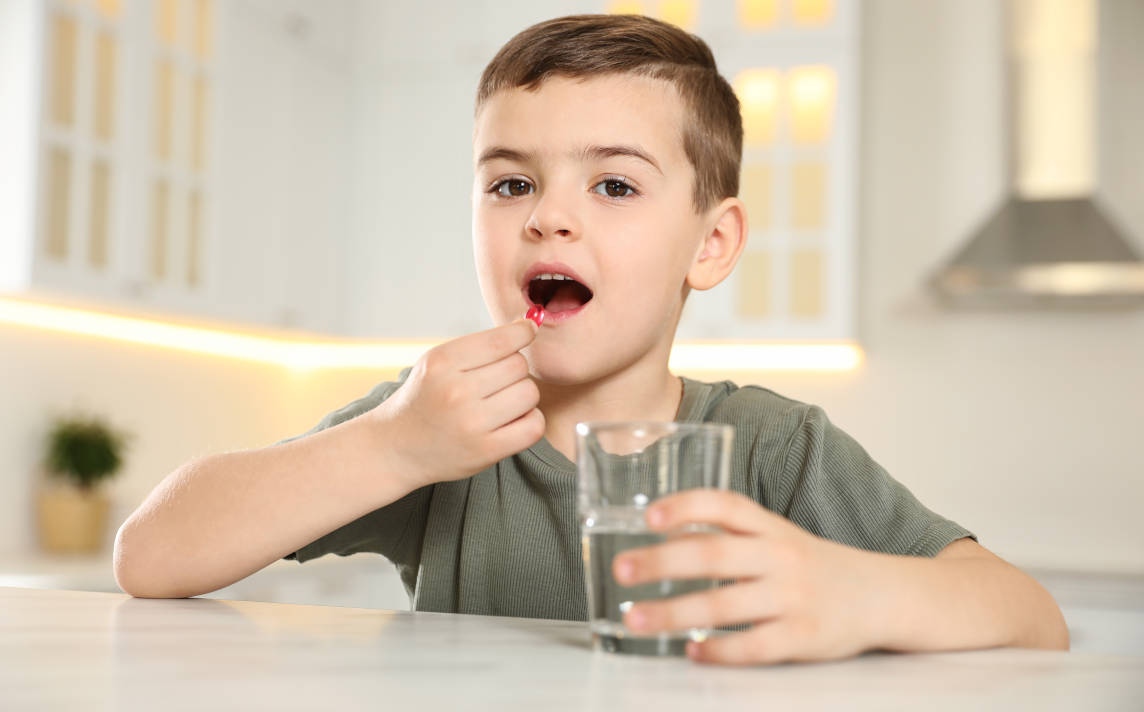 Anak sedang minum suplemen 