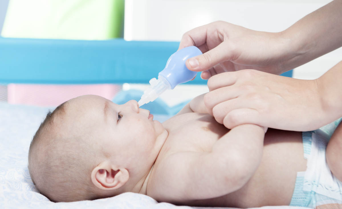 Seorang ibu sedang mengeluarkan ingus dan dahak bayi